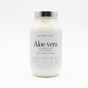 Bottle of aloe vera moisturizer with marine collagen on a desk with a blurred office background